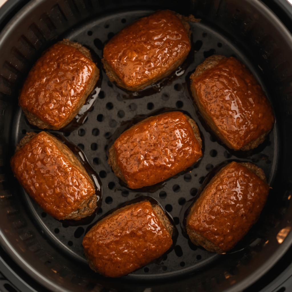 Mini meatloaves in an air fryer basket