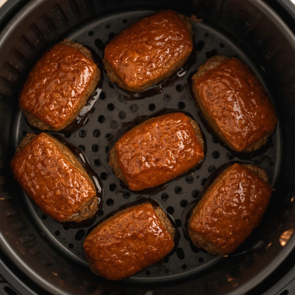 Mini meatloaves in an air fryer basket